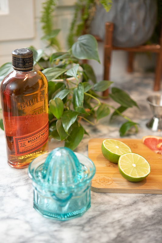 Bottle of bourbon and limes