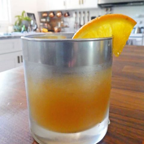cocktail with orange garnish
