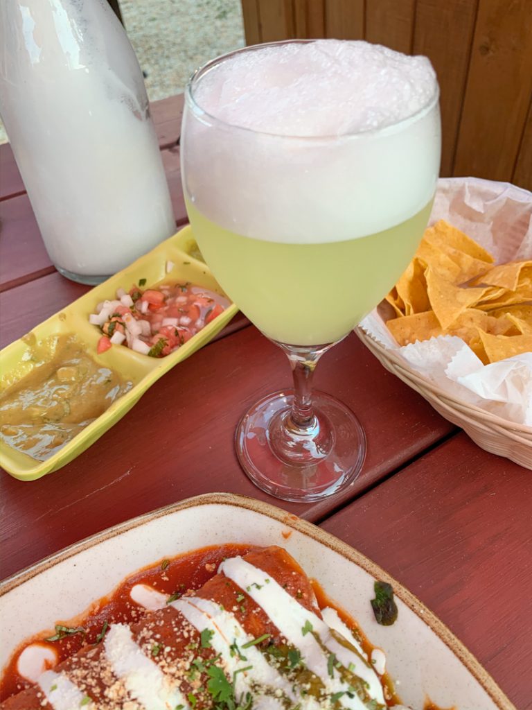 Pisco Sour and food at a restaurant