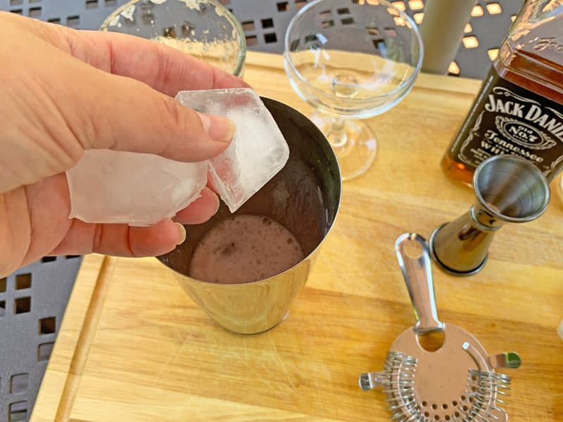 adding ice to shaker
