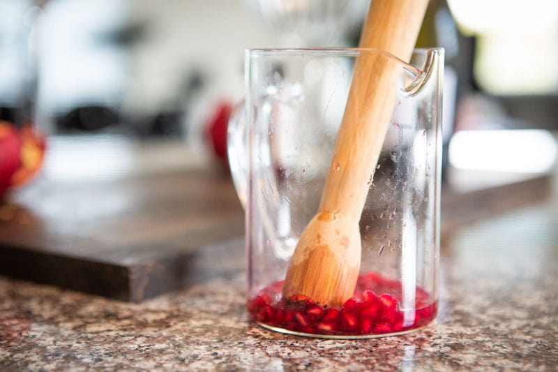muddling pomegranate seeds