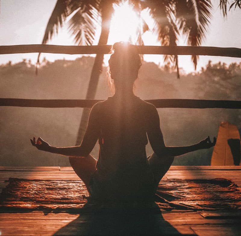 woman doing yoga at sunrise